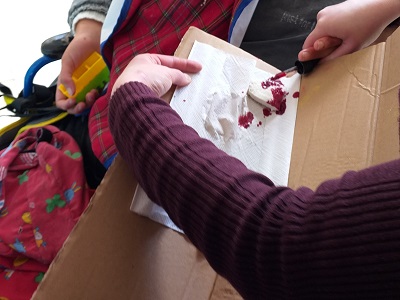 Manuel is helped to strain the access milk from the mixture.