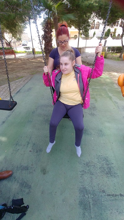 Klajdi choosing a book from the open library.