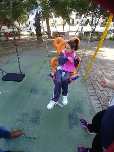 Klajdi choosing a book from the open library.