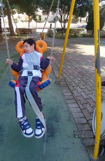 Klajdi choosing a book from the open library.