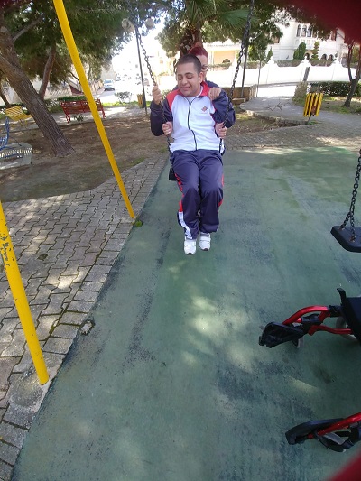 Klajdi choosing a book from the open library.